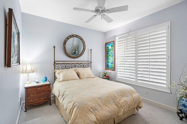 bedroom with ceiling fan and light colored carpet