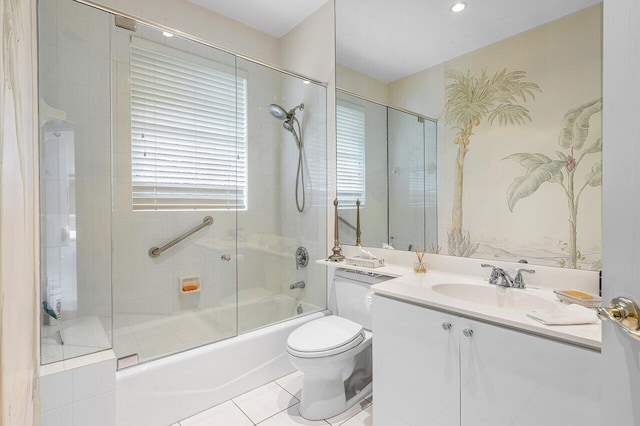 full bathroom featuring combined bath / shower with glass door, vanity, tile patterned floors, and toilet