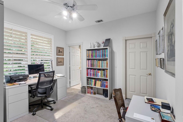 carpeted office featuring ceiling fan