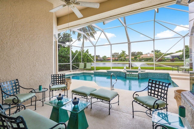 view of pool featuring glass enclosure, an in ground hot tub, a water view, and a patio