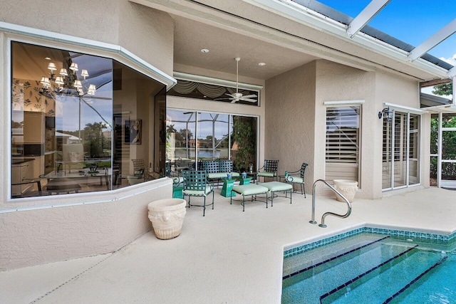 view of patio / terrace with ceiling fan and glass enclosure