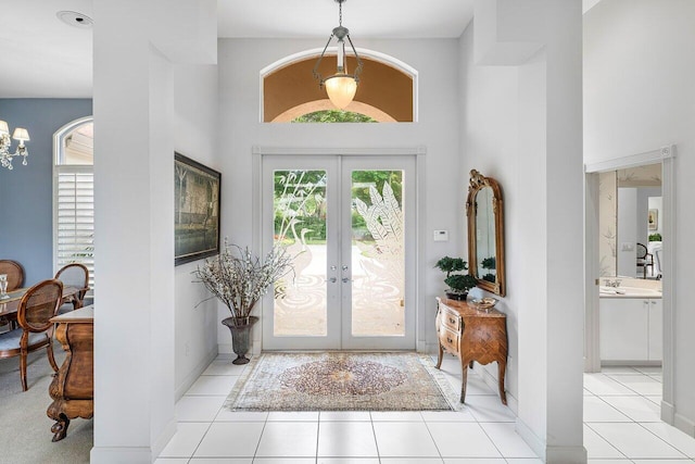 tiled entrance foyer featuring french doors and a high ceiling