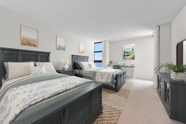 carpeted bedroom featuring a textured ceiling