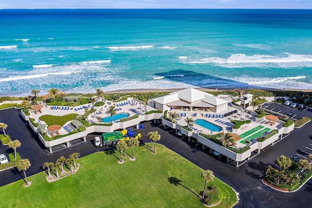 drone / aerial view with a beach view and a water view