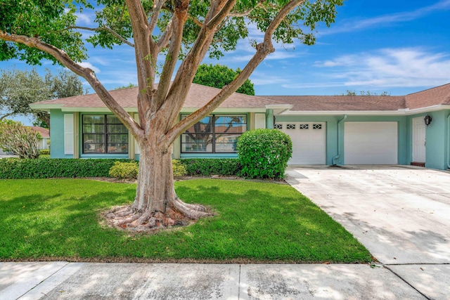 single story home with a front yard and a garage