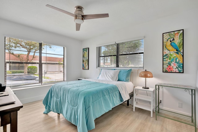 bedroom with ceiling fan and light hardwood / wood-style floors