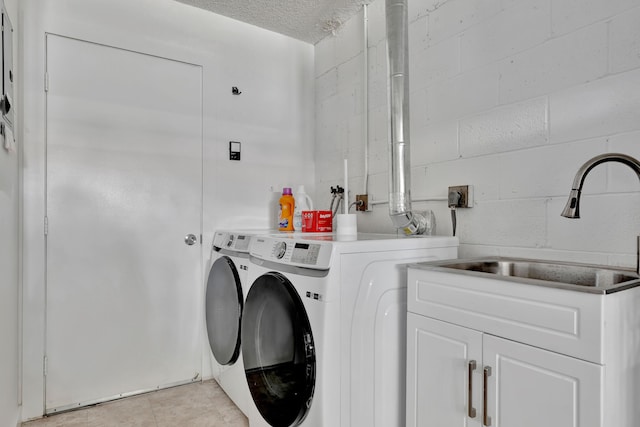 laundry area featuring separate washer and dryer, cabinets, a textured ceiling, and sink