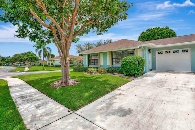 single story home featuring a front yard and a garage