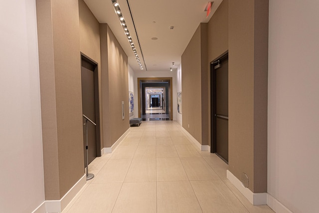 corridor featuring light tile patterned floors