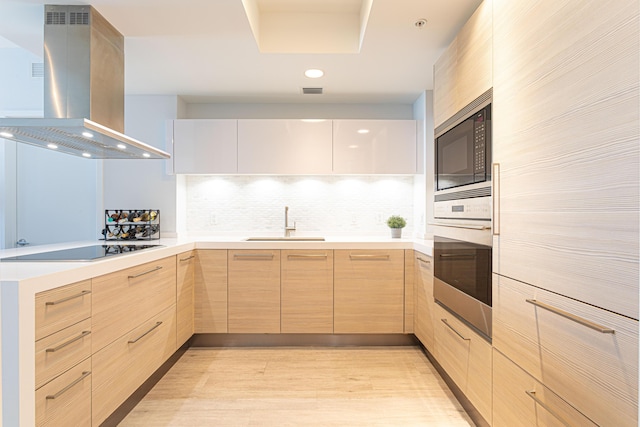 kitchen with island range hood, black electric stovetop, built in microwave, sink, and oven