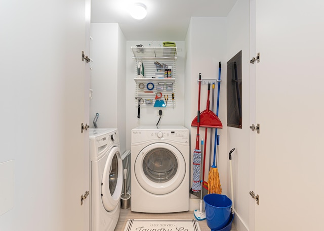 laundry room with light tile patterned flooring and washing machine and clothes dryer