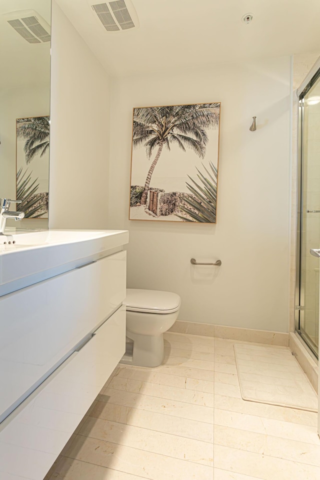 bathroom with toilet, an enclosed shower, and vanity