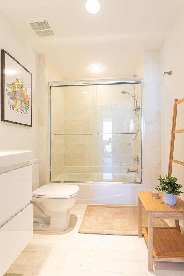 full bathroom featuring toilet, enclosed tub / shower combo, tile patterned floors, and vanity