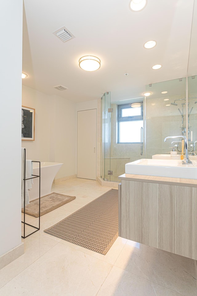 bathroom with vanity, shower with separate bathtub, and tile patterned flooring