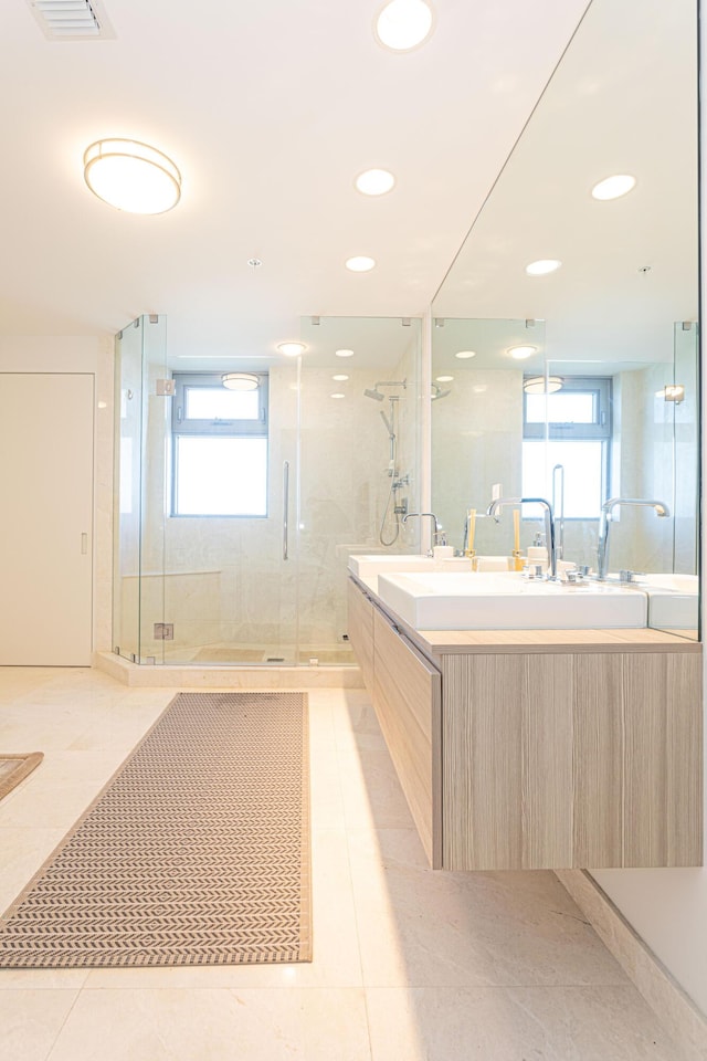 bathroom featuring a shower with shower door, tile patterned floors, and vanity