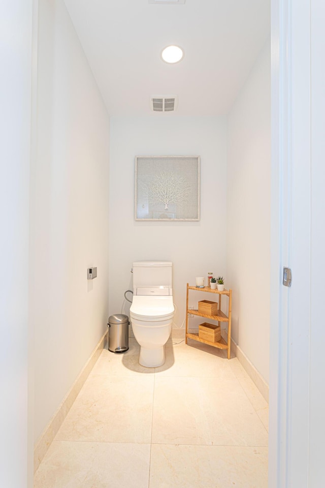 bathroom with toilet and tile patterned floors