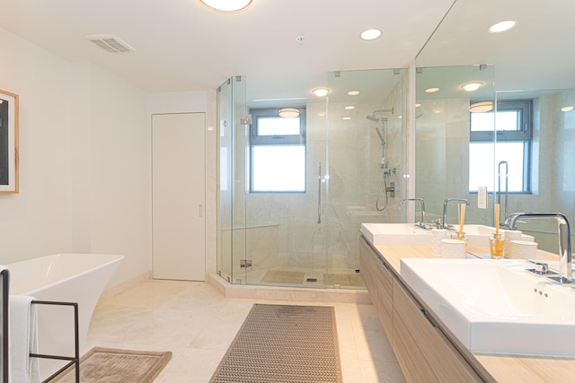 bathroom featuring shower with separate bathtub, vanity, tile patterned flooring, and a healthy amount of sunlight