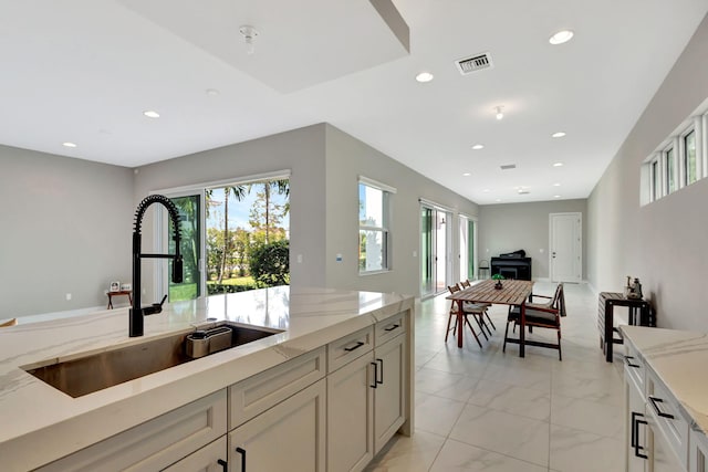 kitchen with light stone counters and sink