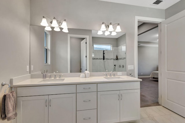 bathroom featuring vanity and tiled shower