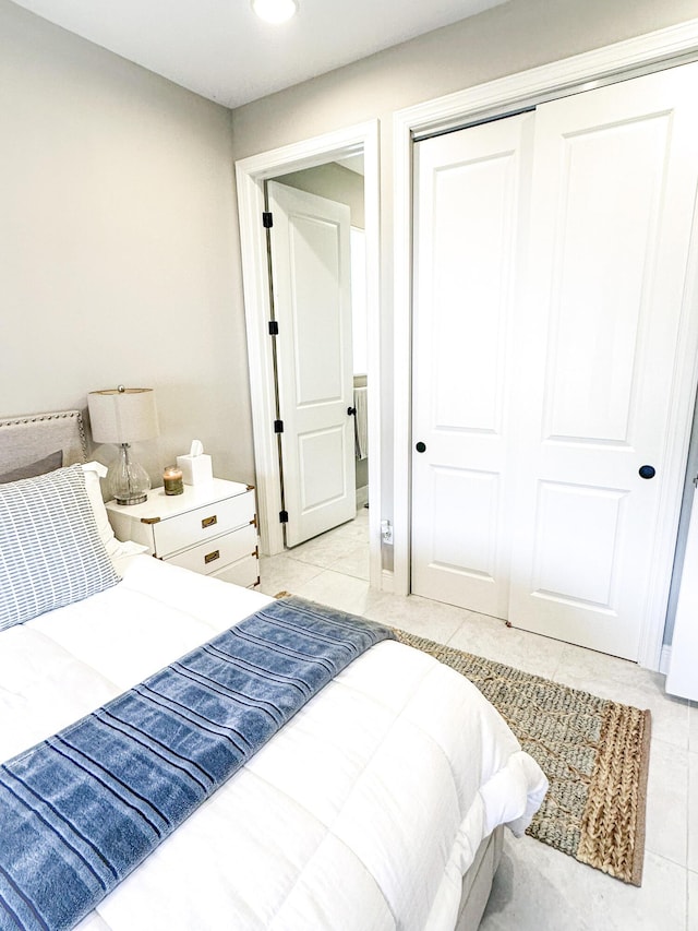 tiled bedroom featuring a closet