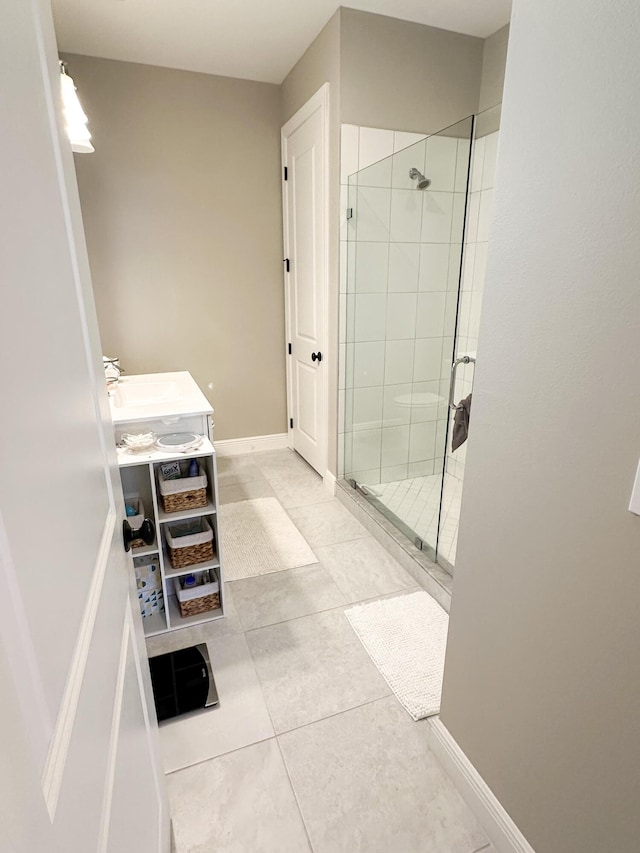 bathroom featuring an enclosed shower, vanity, and tile patterned flooring