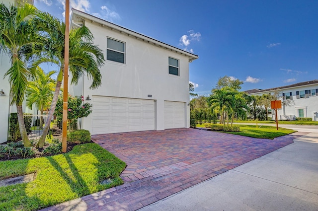 view of side of home featuring a yard and a garage