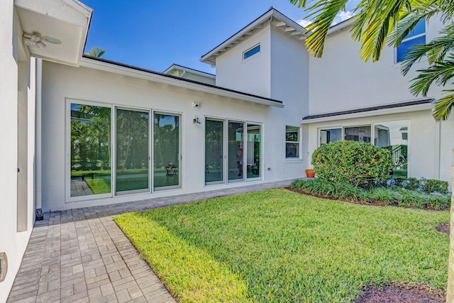 rear view of property with a lawn