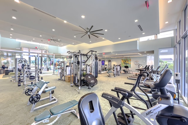 gym featuring ceiling fan and light colored carpet