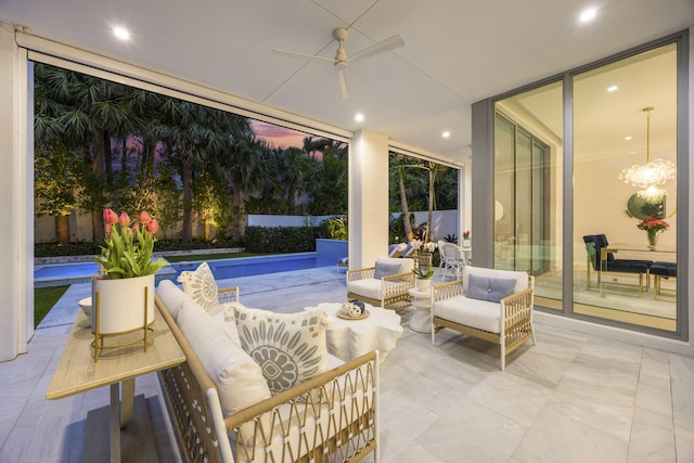 view of patio / terrace with ceiling fan and an outdoor living space