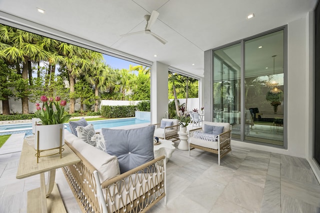 view of patio with ceiling fan and a fenced in pool