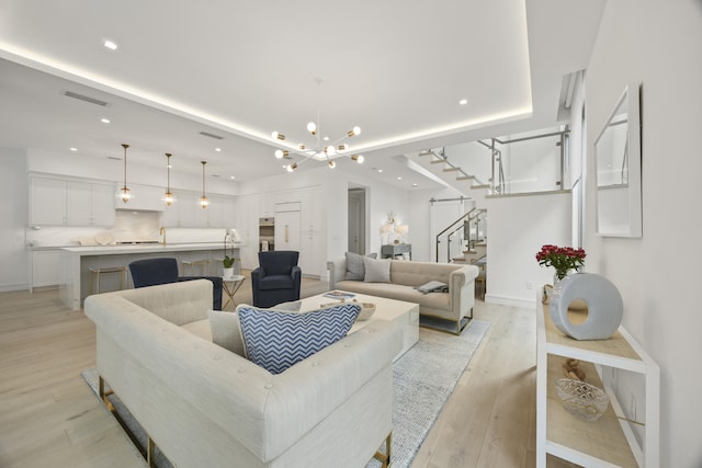 living room featuring light hardwood / wood-style flooring and a notable chandelier