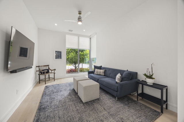 living room with ceiling fan and light hardwood / wood-style floors