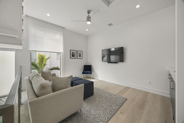 living room featuring ceiling fan and light hardwood / wood-style floors