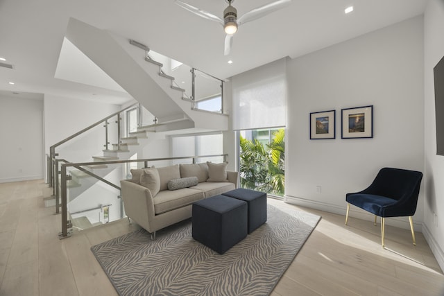 living room featuring light hardwood / wood-style floors and ceiling fan