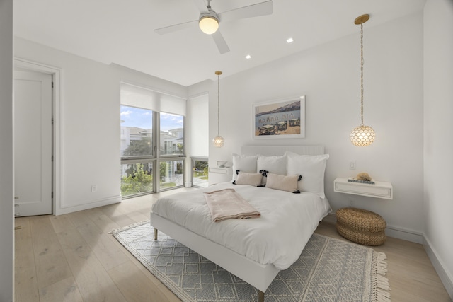 bedroom with ceiling fan and light hardwood / wood-style floors