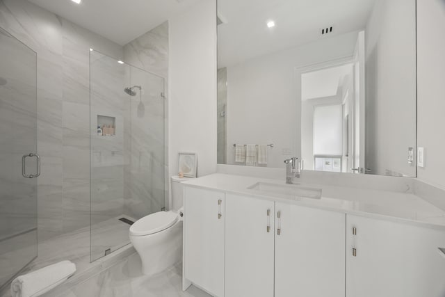 bathroom with an enclosed shower, vanity, and toilet