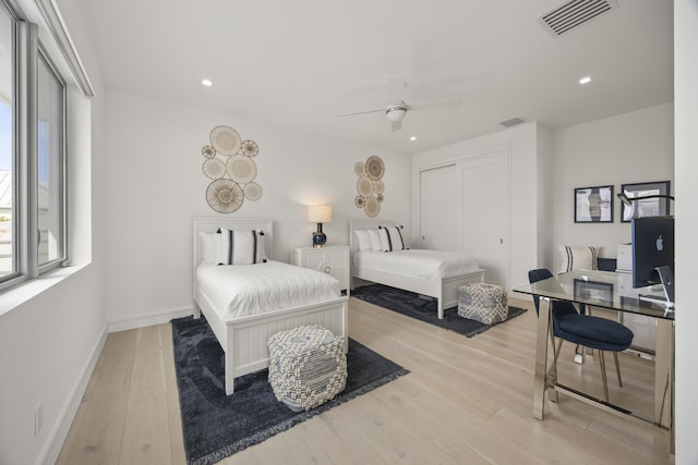 bedroom with ceiling fan, a closet, and light wood-type flooring