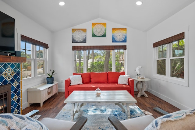 living room featuring dark hardwood / wood-style flooring and vaulted ceiling