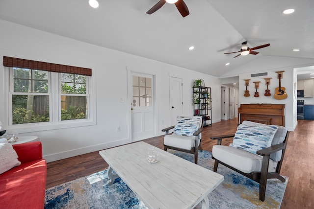 living room with ceiling fan, dark hardwood / wood-style flooring, and vaulted ceiling