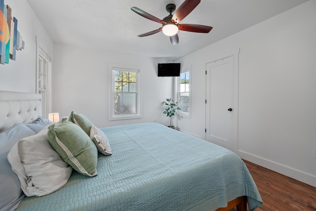 bedroom featuring ceiling fan and dark wood-type flooring