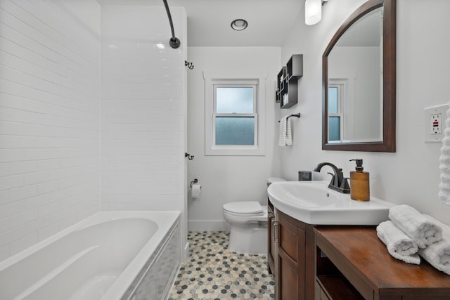 full bathroom featuring toilet, vanity, and tiled shower / bath combo