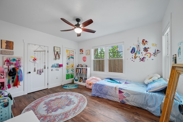 bedroom with ceiling fan and dark hardwood / wood-style flooring