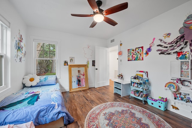 bedroom with dark wood-type flooring and ceiling fan