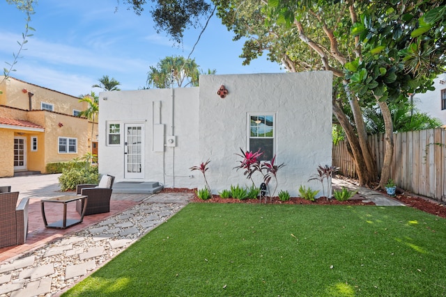 view of front of house with a front lawn and a patio area