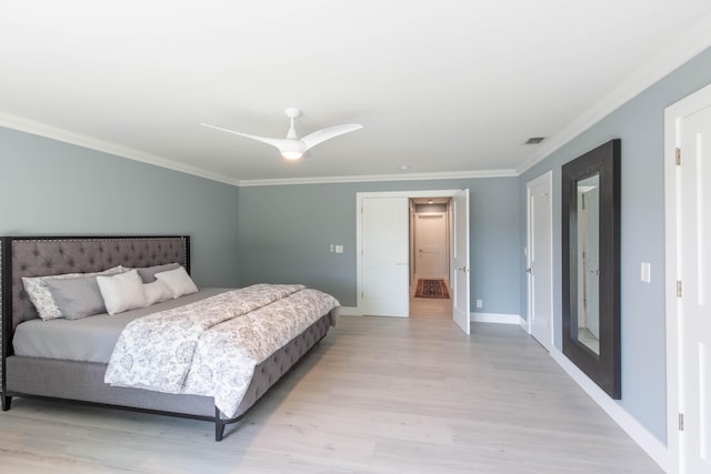 bedroom featuring ceiling fan, light hardwood / wood-style floors, and ornamental molding