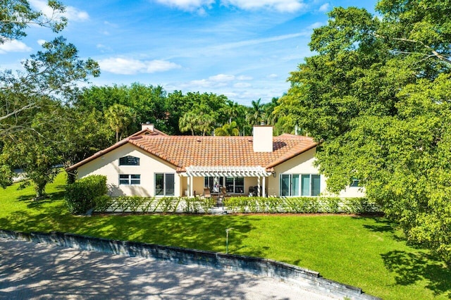 rear view of house with a lawn