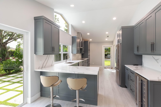 kitchen with gray cabinetry and kitchen peninsula