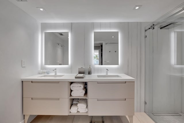 bathroom featuring vanity, a shower, and wood-type flooring