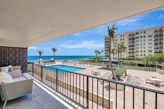 balcony with a water view and a patio area