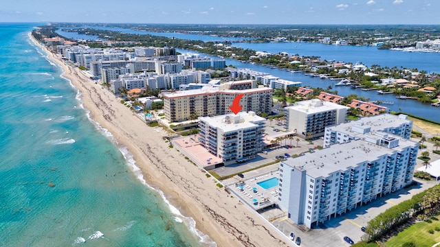 drone / aerial view featuring a view of the beach and a water view